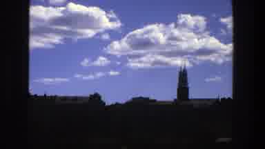 Stockholm Sweden (1975): Clouds Floating Through A Blue Sky Over A Dark Lit City