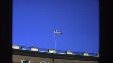 Stockholm Sweden (1975): View Of Flag Flying On Top Of Brown Building On A Clear