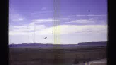 Arizona (1969): A Gray Car Driving On The Road In A Large Desert With Many