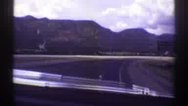 Arizona (1969): Approaching View Of Mountains Green Trees And Large Puffy Grey