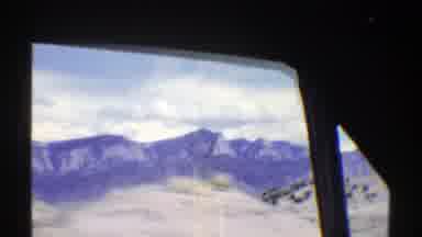 Arizona (1969): Driving Down The Highway With Several Mountains To The Side And