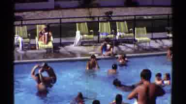 Arizona (1969): People Having Good Time Swimming In Pool While Woman Reads