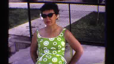 Arizona (1969): A Woman In A Green Top Wearing Sunglasses And A Boy Wearing A Blue