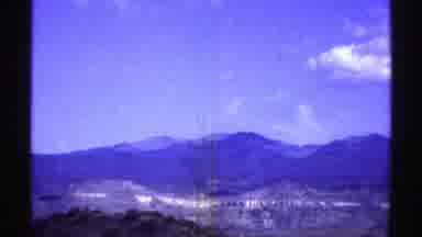 Arizona (1969): View Of Mountains Green Trees Blue Sky And Small White Clouds On A