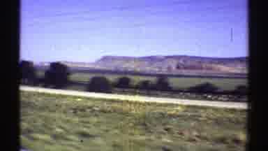 Arizona (1969): Vehicle Moves Through Mountainous Landscape Through The Asphalt