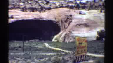 Arizona (1969): A Daytime Scene Shot From A Car Or Plane Of A Natural Cave