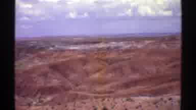 Arizona (1969): View Of Brown Hills With Puffy White Clouds On A Clear Day