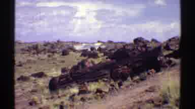 Arizona (1969): Passing View Of Brown Hills Blue Sky And White And Tan Camper On A