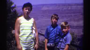 Arizona (1969): Small Boy Wearing Blue Shirt Waves At Camera On A Bright Sunny Day