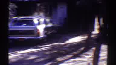 Arizona (1969): The Yard Of A House With Lot Of Plants And Some Vehicles In The