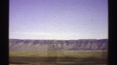 Arizona (1969): A Highway In A Desert Surrounded By Big Mountains On A Sunny Day