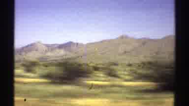 Arizona (1969): Camera Panning Over A Dessert Type Of Landscape With Some Green