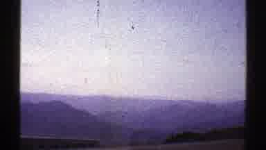 Arizona (1969): Bird Flies Over A Pale Blue Mountain Range That Can Be Seen From