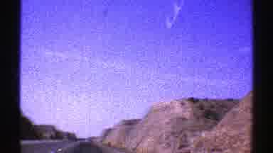 Arizona (1969): View Of Green Mountaineering And Brown Buildings On A Sunny Day