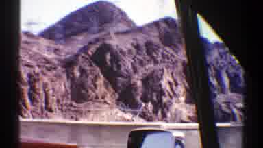 Arizona (1969): Driving On The Road Passing By Several Cars And Buses Stopped With