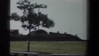Baltimore Maryland (1961): View Of Brown Building Crane And Tree On A Sunny Day
