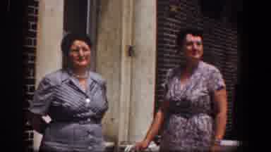 Baltimore Maryland (1961): Two Women Stand Near Red Brick Building On A Clear