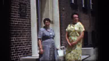 Baltimore Maryland (1961): Two Women Stand Near Red Brick Building On A Bright