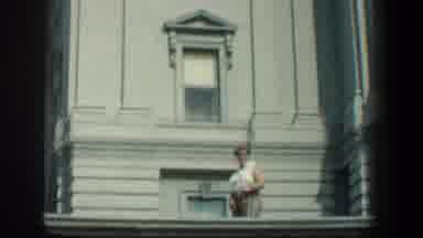 Baltimore Maryland (1961): Woman Wearing White Shirt Stands In Front Of White
