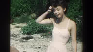 Baltimore Maryland (1961): Woman Wearing Pink Swimwear Stands Next To Person