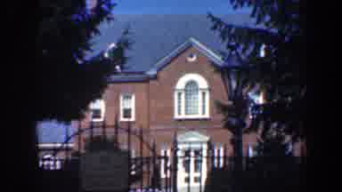Baltimore Maryland (1961): A Two-Story Building Stands Behind An Iron Gate And