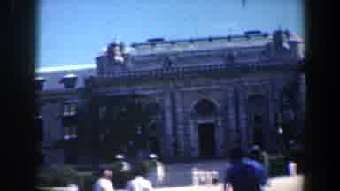 Baltimore Maryland (1961): A Big Gray Building With A Garden And Some People