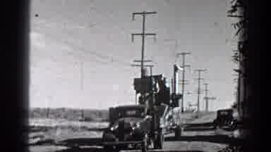 California (1936): Old Tractor Pulling Car On Clay Road With Energy Poles In The