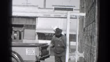 California (1936): A Man Unlatching The Back Of His Truck To Load It Up