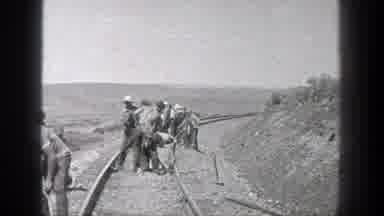 California (1936): Construction Workers Are Busy On A Rail Site Digging With