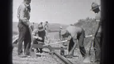 California (1936): A Group Of Men Working On Building The Tracks Of A Railroad