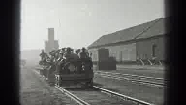 California (1936): Freight Car Traveling By Rail Approached A Large Group Of