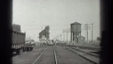 California (1936): View Of Train Tracks And Water Tower On A Clear Day