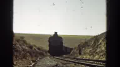 California (1936): Black Locomotive Approaches Camera On A Clear Day