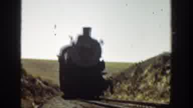 California (1936): Old Train Moving Through Valley As Workers Make More Train