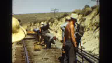 California (1936): Men Wearing Blue Shirts Working On Railroad Tracks On A Sunny