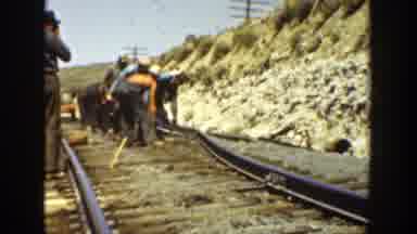 California (1936): Construction Workers Are Busy On A Rail Site As A Man Holding