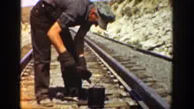 California (1936): Man Wearing Grey Hat Cleaning Object And Turkeys Eating From