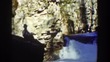 California (1936): Man Sitting On Rocky Side Of Waterfall