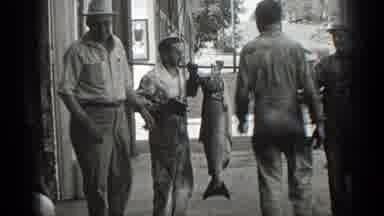 California (1936): Two Men Hold Up A Big Fish Hanging From A Pole While They Stand