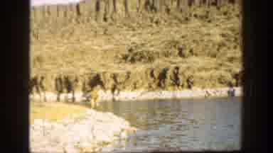 California (1936): Male Walking On The Rocky Side Of The Water Tosses A Rock Into