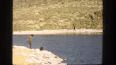 California (1936): A Man And His Dog Playing Fetch In A River
