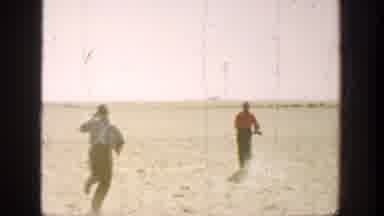 California (1936): Two Hunters Running At A Fallen Duck At A Reset Place