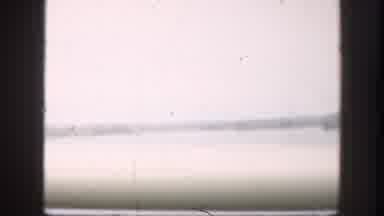 Kansas-1958: A Vehicle Is Moving Through A Bridge Over The River