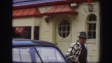 Kansas-1958: Man In Hat And Jacket Exiting Car Near Historic Building