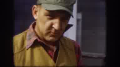 Kansas (1958): Man Smokes A Cigar And Holds A Gun While Walking Outside