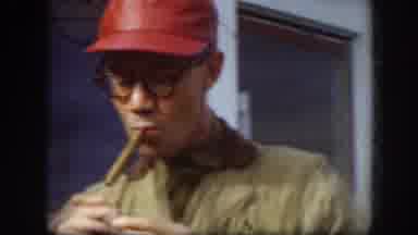 Kansas (1958): Man In Red Cap And Glasses Lighting A Cigar