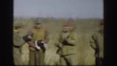 Kansas (1958): Four Men Wearing Tan Jackets Stand In Field With Rifles On A Sunny