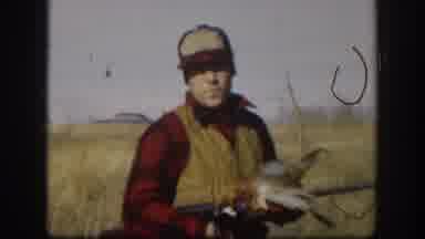 Kansas (1958): Hunter Holding A Duck That He Just Killed Holding A Rifle