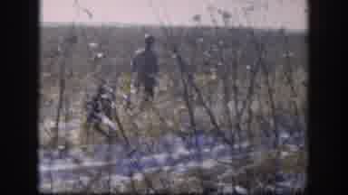 Kansas (1958): Hunter Walking On Woods With His Rifle And Waving At The Camera