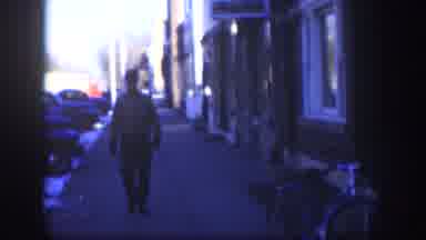 Kansas (1958): Man Wearing Grey Jacket Tips Hat To Camera On A Sunny Day